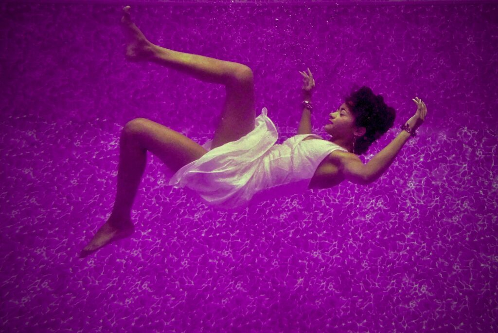 A woman falls through a purple dreamscape