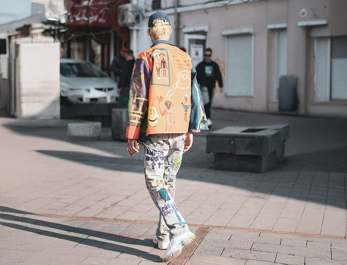 Man walking on plaza wearing vintage clothes