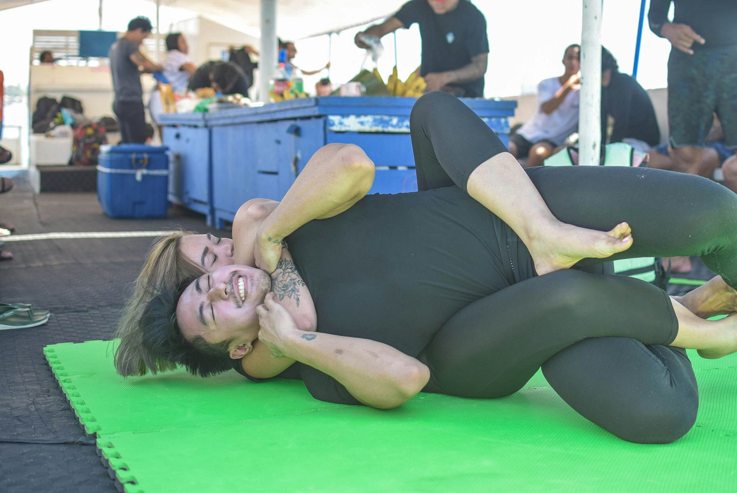 A man and a woman wrestle. She's clearly winning. 